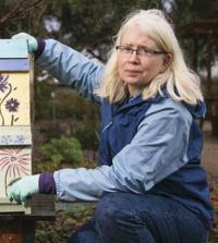 Christine Casey with hands on Langstroth hive